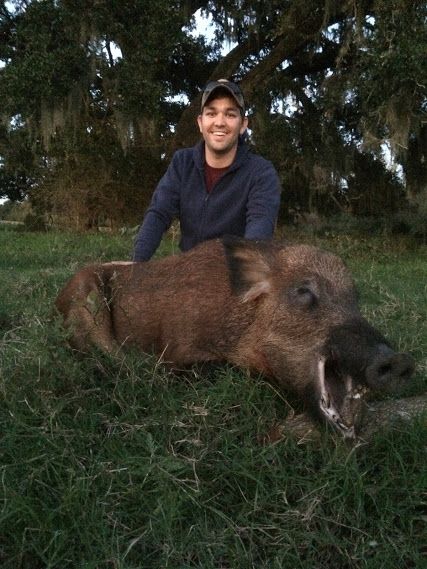A hunter with a large wild boar